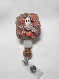 Badge reel orange flower ghost